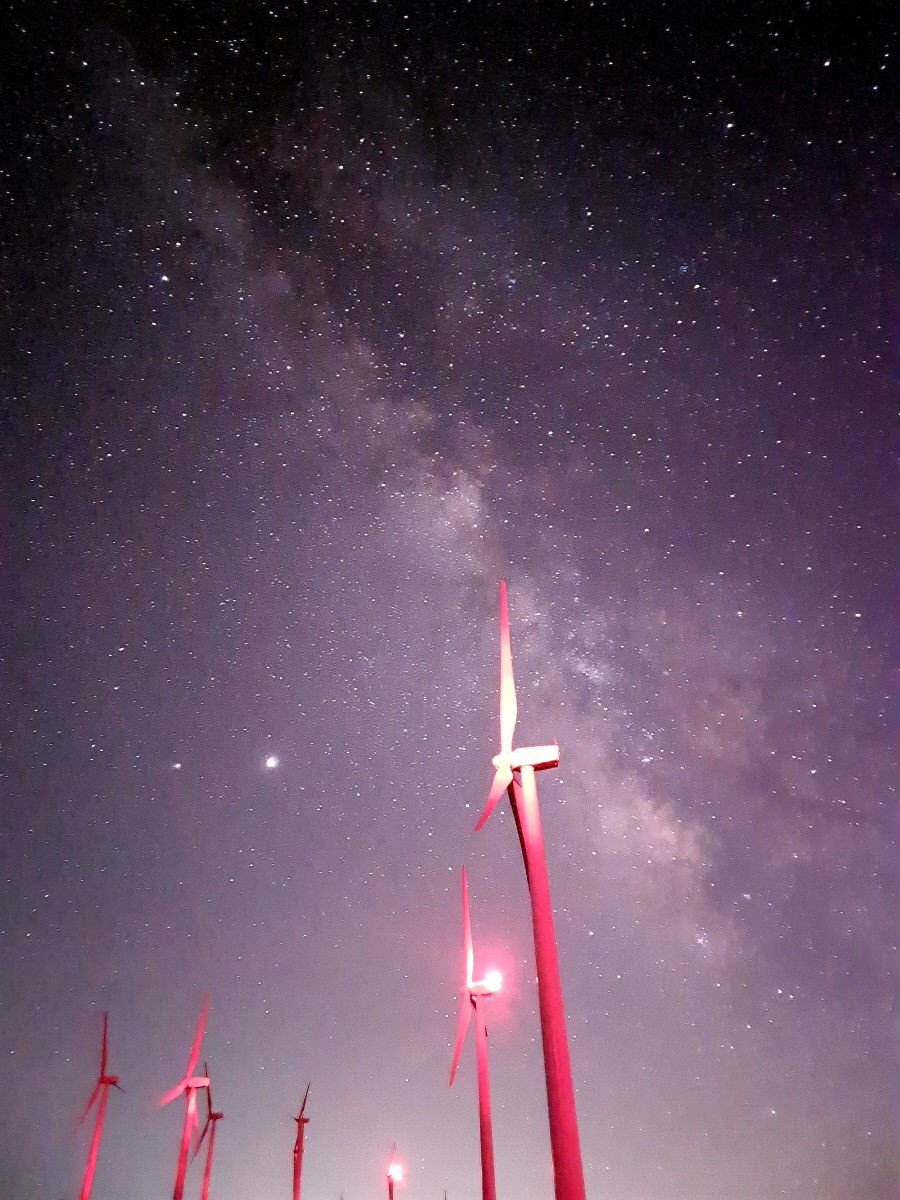 Wide angle of windmills against a background of the Milky Way galaxy shot with the Galaxy S20 Ultra.