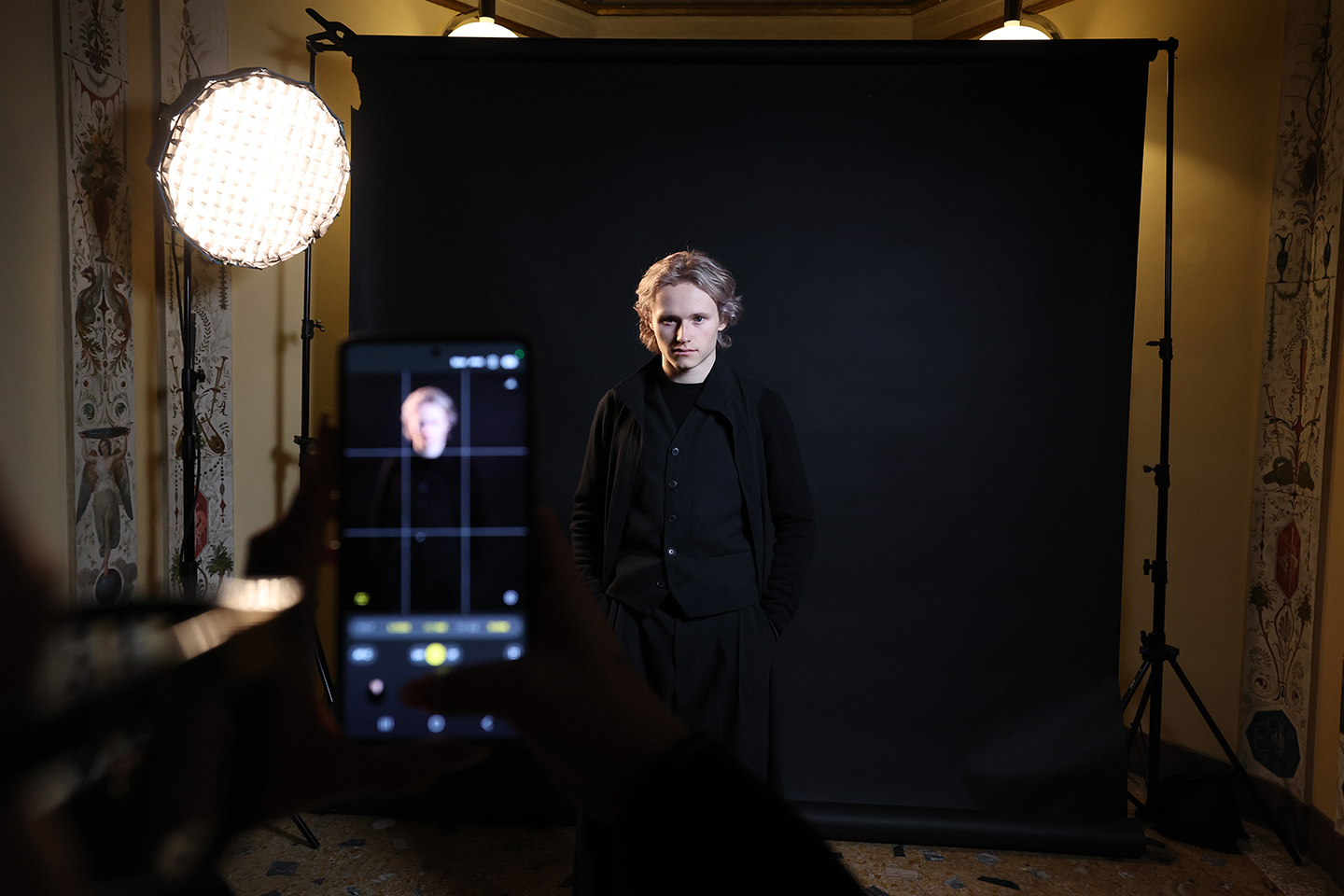 Team Samsung Galaxy athlete Ilia Malinin poses for a Victory Profile in a dark room at Samsung House during the Hwaiting Night event.