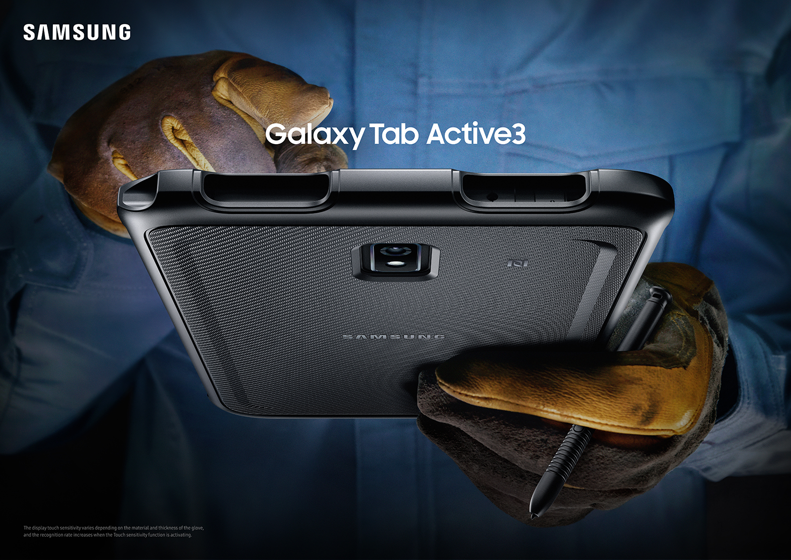 A pair of hands in work gloves hold up the ruggedly built Galaxy Tab Active3.